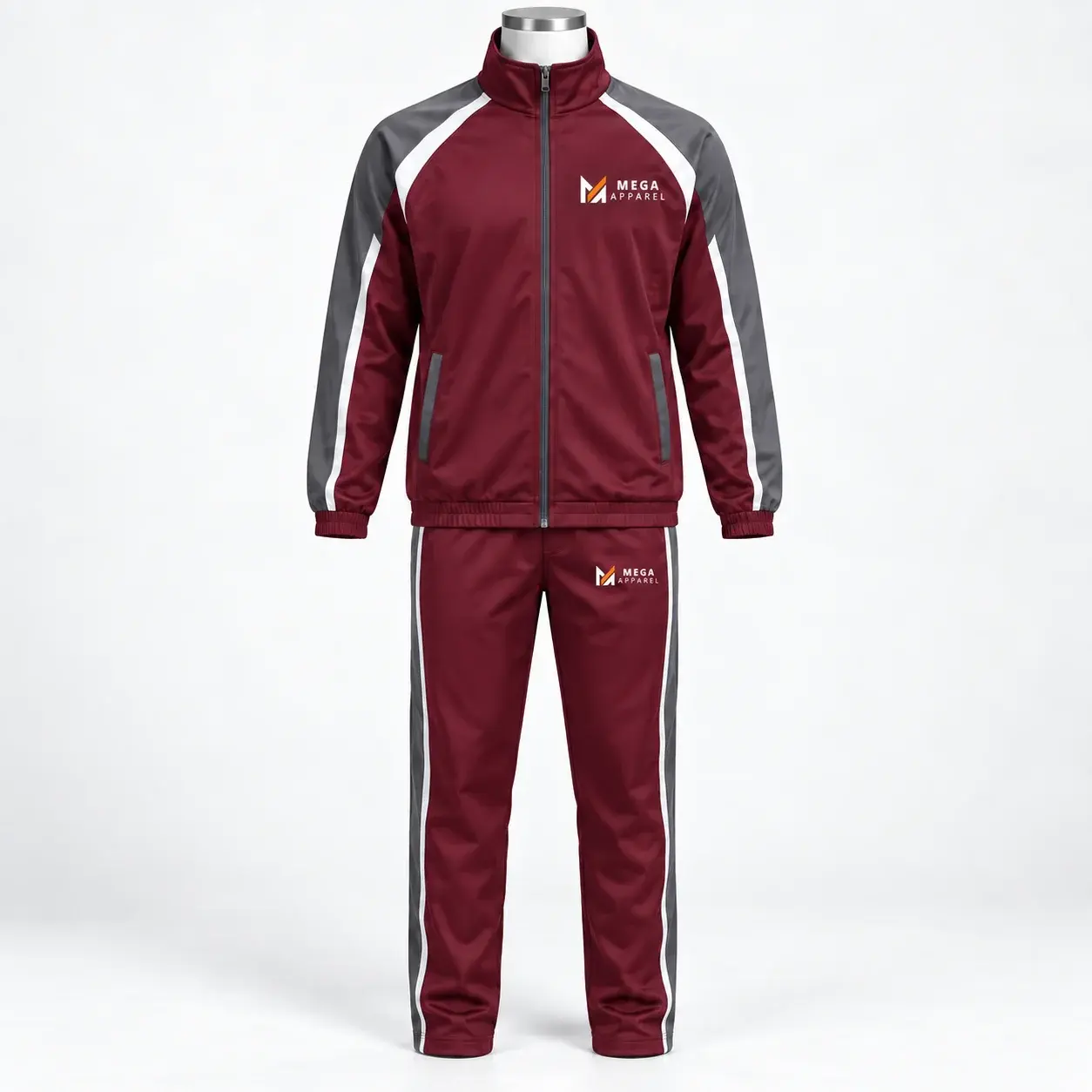 Maroon school and academy tracksuit with gray and white contrast panels, zip-up jacket, matching pants, and Mega Apparel logos on the chest and pants.